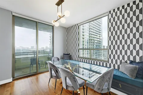 a view of a dining room with furniture large windows and wooden floor