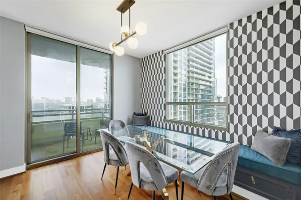 a view of a dining room with furniture large windows and wooden floor