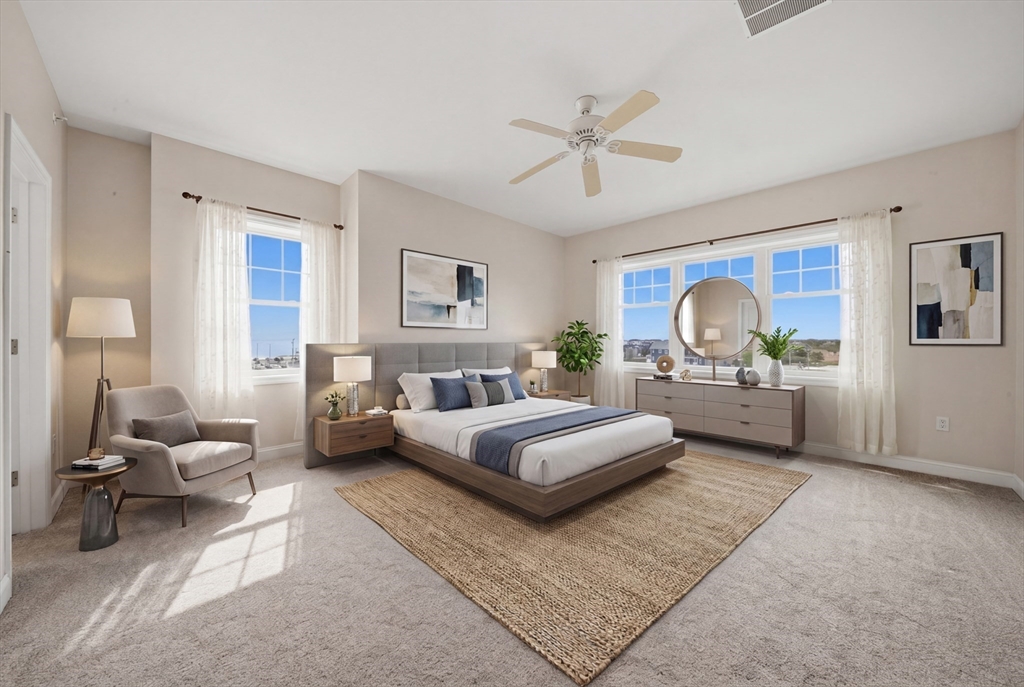 233 Beach Road, Unit A11 Salisbury, MA 01952 - Photo 21 of 37 a bedroom with a large bed and a couch