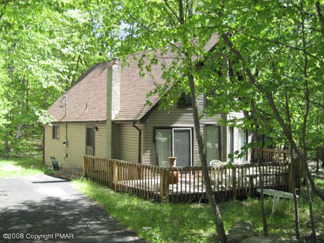 1071 Canterbury Road Bushkill, PA 18324 - Photo 1 of 6 a front view of a house with a garden and plants