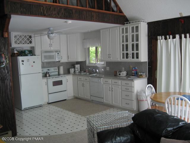 1071 Canterbury Road Bushkill, PA 18324 - Photo 3 of 6 a kitchen with granite countertop a sink appliances cabinets and furniture
