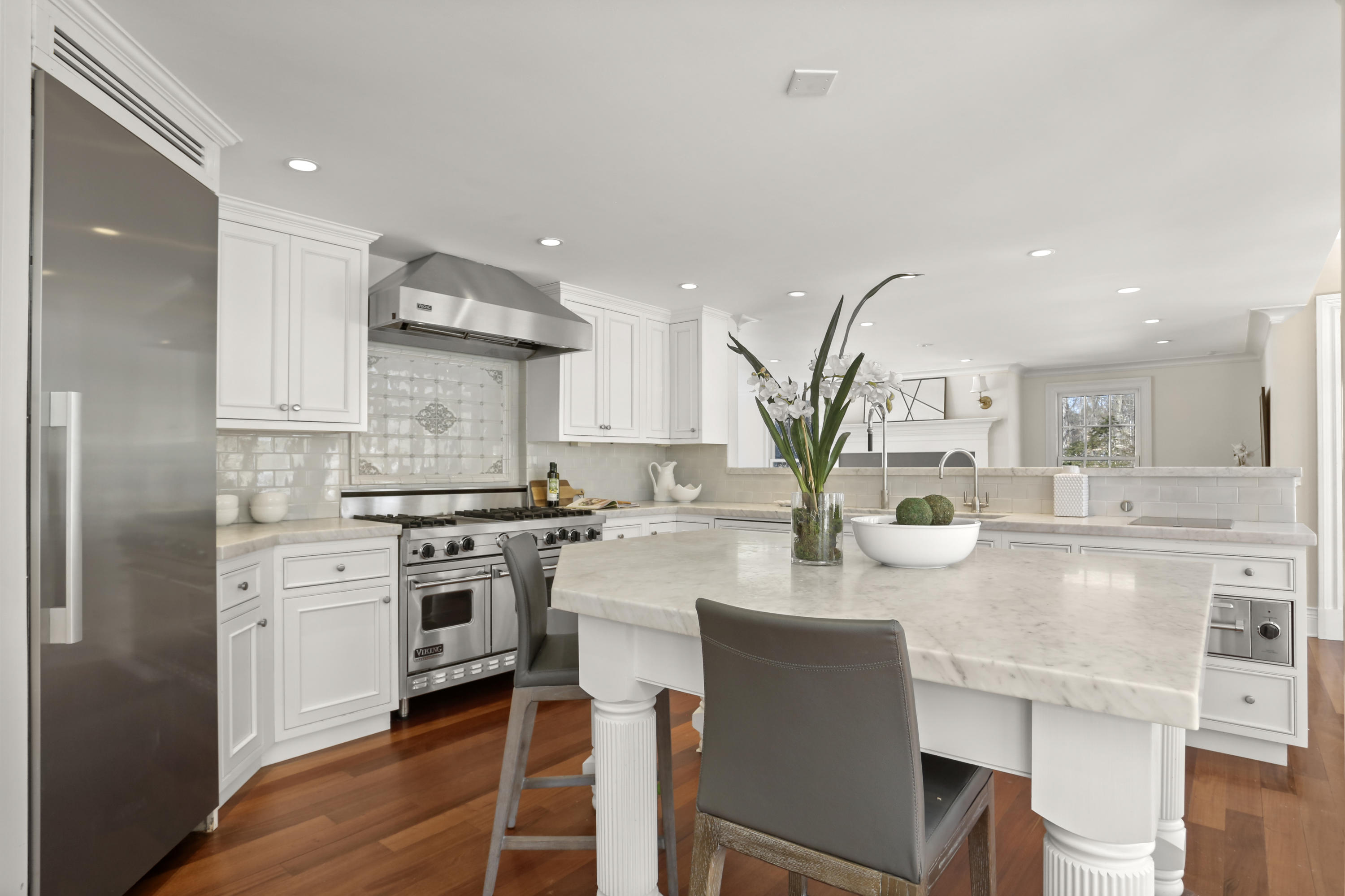 89 Dabney Road New Canaan, CT 06840 - Photo 18 of 40 a kitchen with stainless steel appliances granite countertop a table chairs sink and cabinets