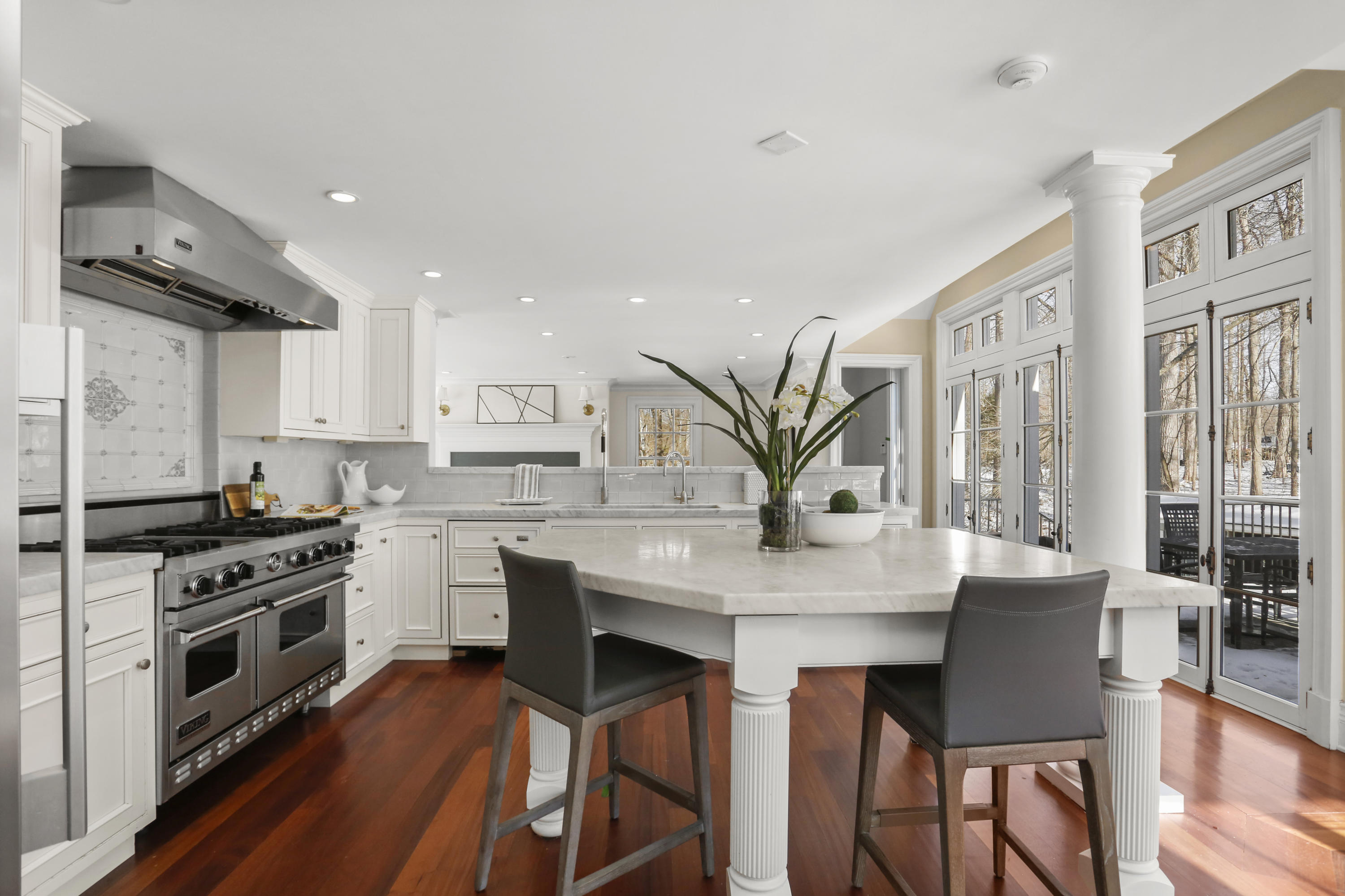 89 Dabney Road New Canaan, CT 06840 - Photo 19 of 40 a kitchen with stainless steel appliances a dining table and chairs