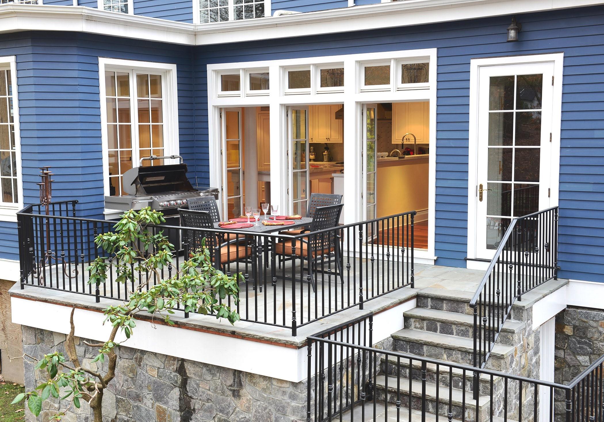 89 Dabney Road New Canaan, CT 06840 - Photo 3 of 40 a view of a brick house with large windows and flower plants