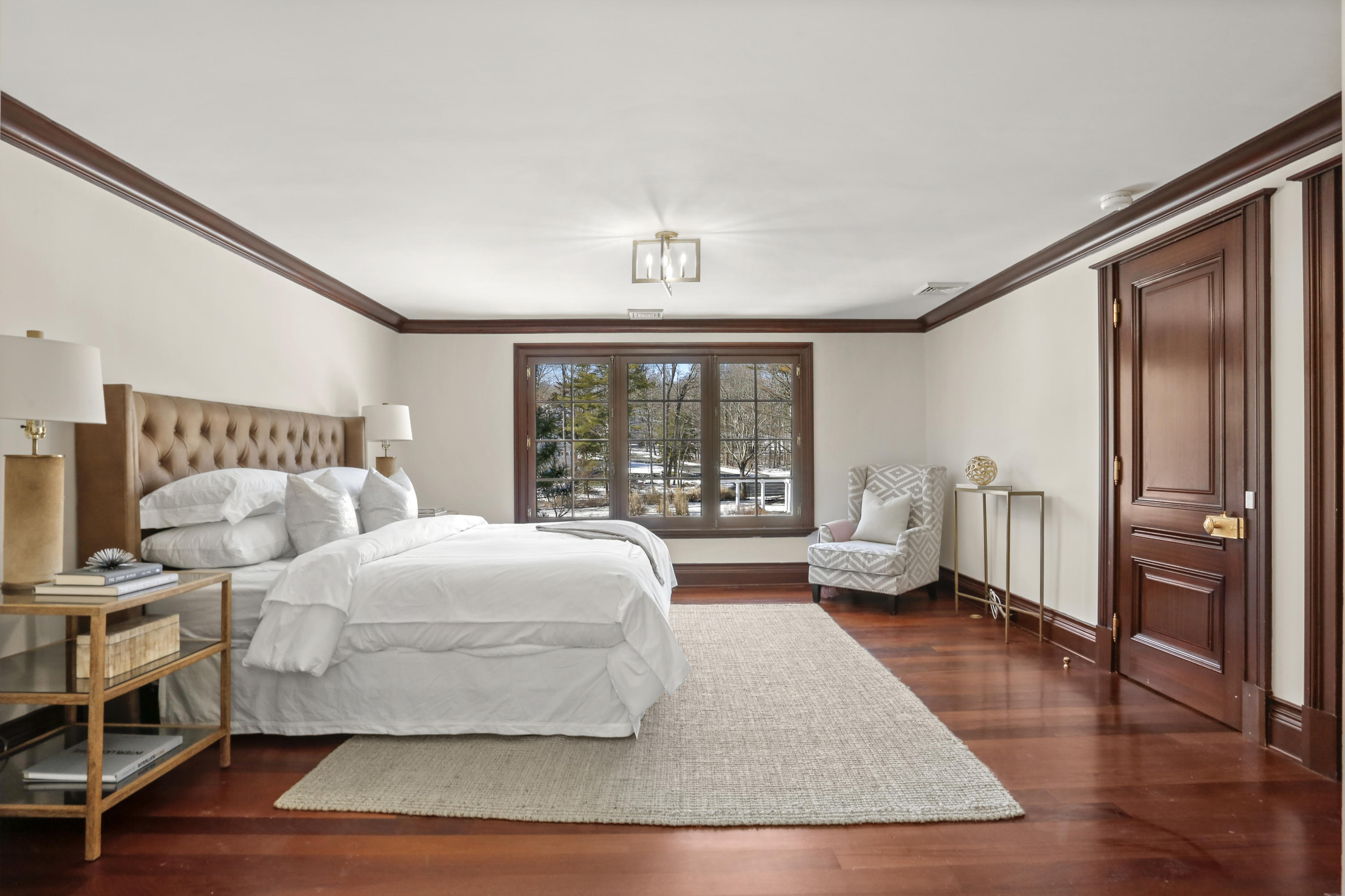 89 Dabney Road New Canaan, CT 06840 - Photo 24 of 40 a bedroom with a bed couch and a large window