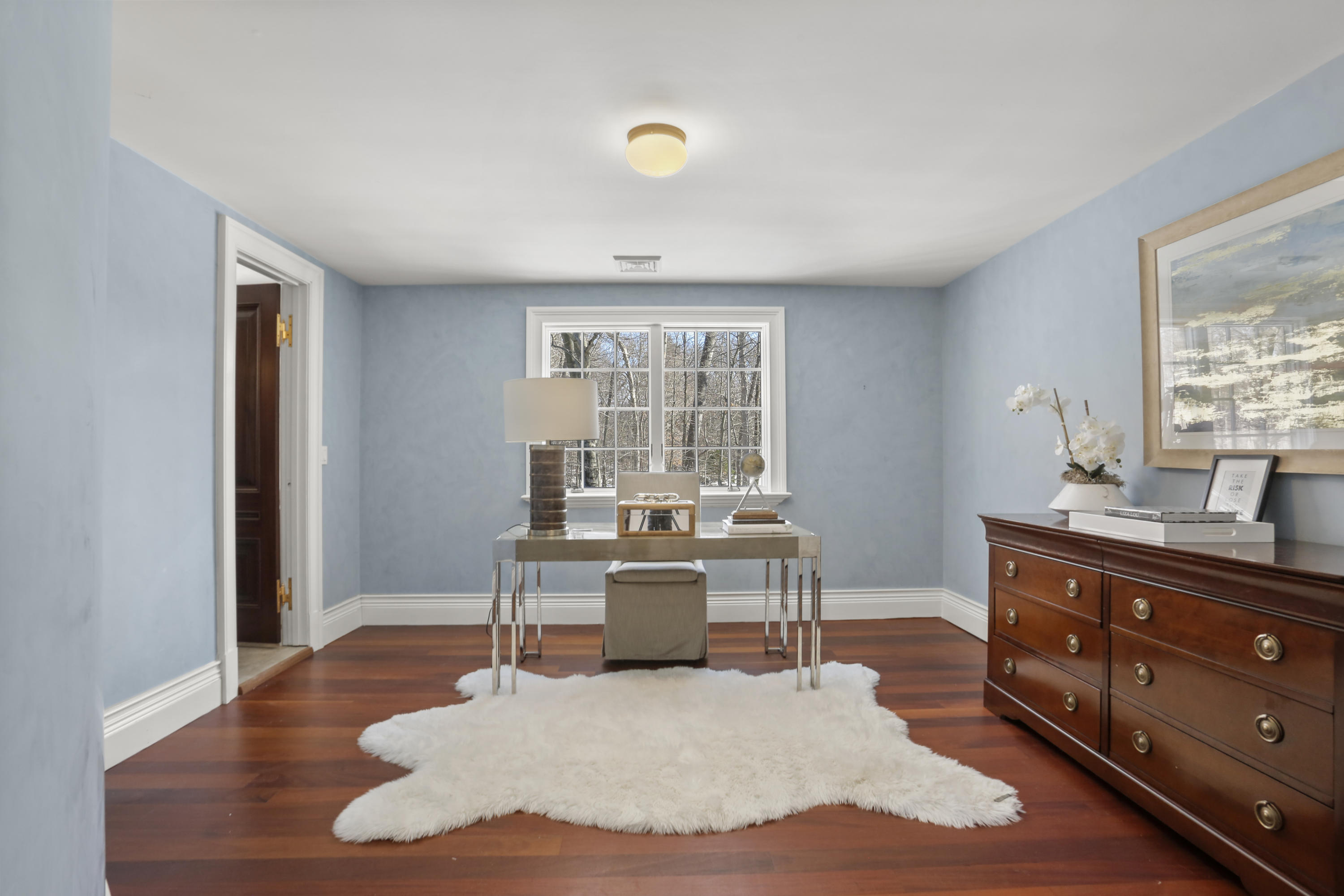 89 Dabney Road New Canaan, CT 06840 - Photo 29 of 40 a living room with furniture a large window and wooden floor