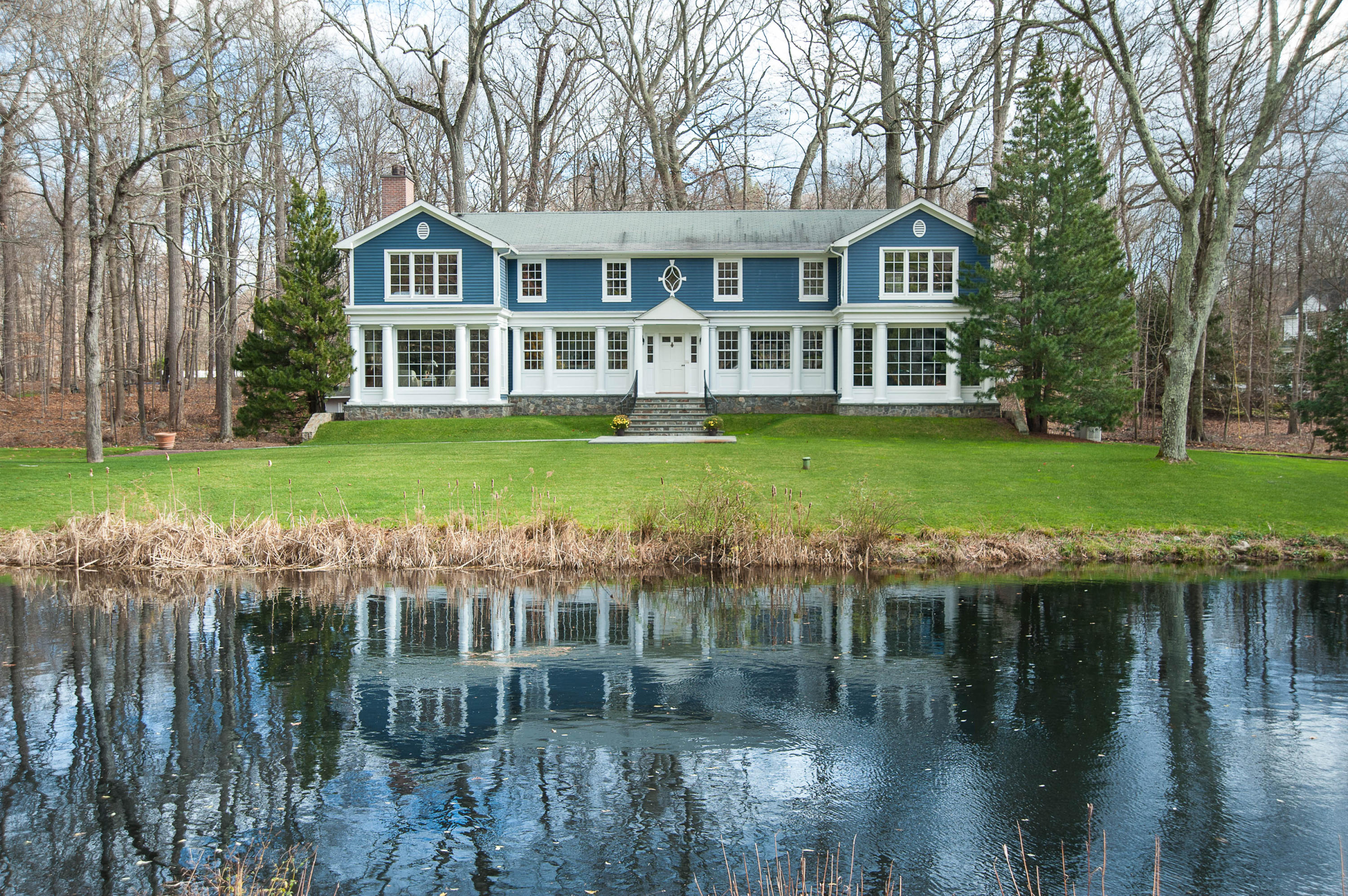 89 Dabney Road New Canaan, CT 06840 - Photo 35 of 40 a view of a house with a yard from a lake view