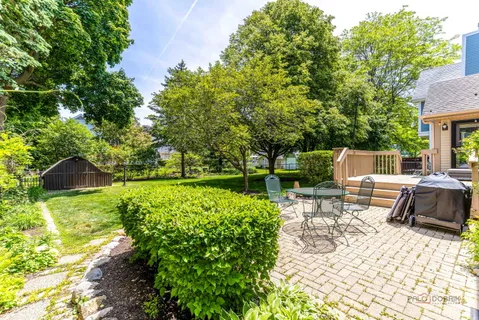 a front view of a house with a yard and outdoor seating