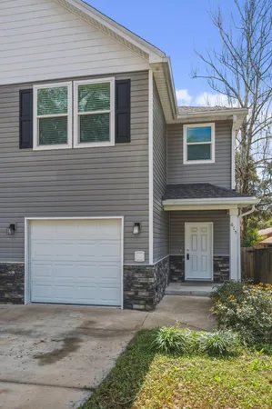 a front view of a house with garden