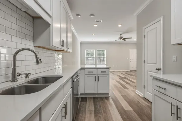 a kitchen with a sink and a refrigerator