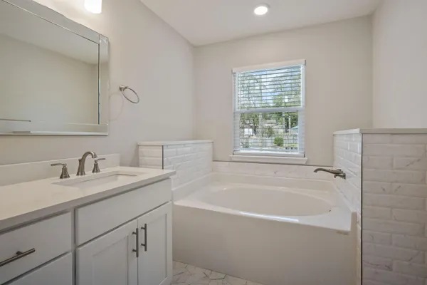 a white bath tub sitting next to a white sink
