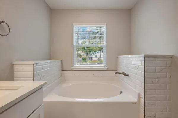 a bathroom with a bathtub and window