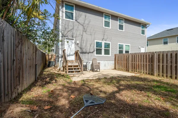 a backyard of a house with table and chairs
