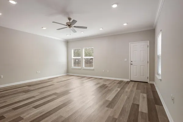 wooden floor in an empty room with a window