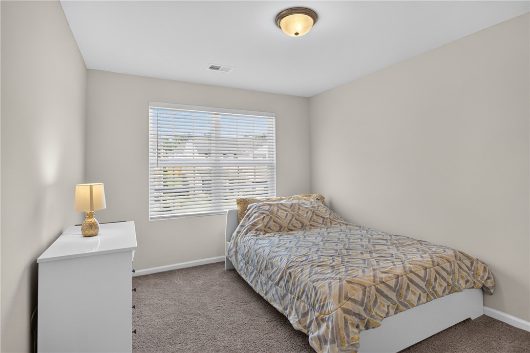 1081 Edenbrooke Circle Anderson, SC 29621 - Photo 30 of 46 A well-lit bedroom offering a cozy, inviting retreat with soft carpeting and natural light.