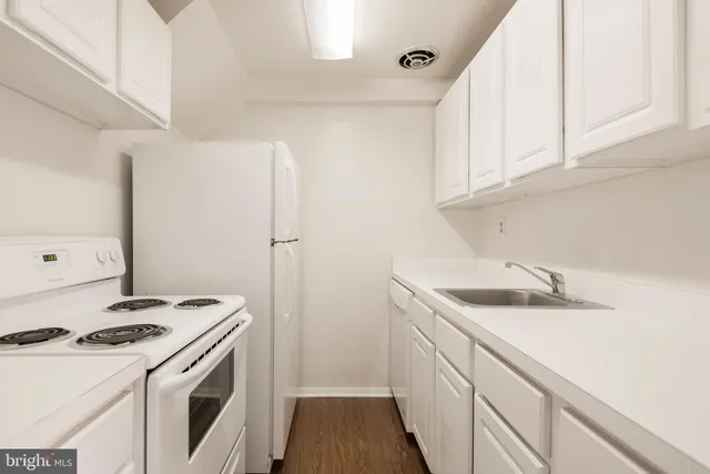 a kitchen with a sink stove and cabinets