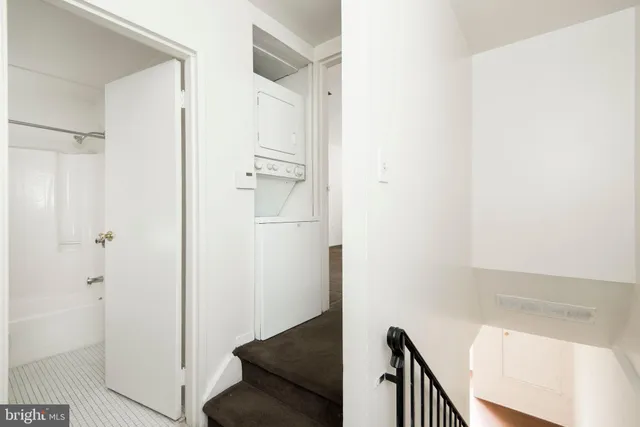 a view of a hallway with wooden floor and entryway