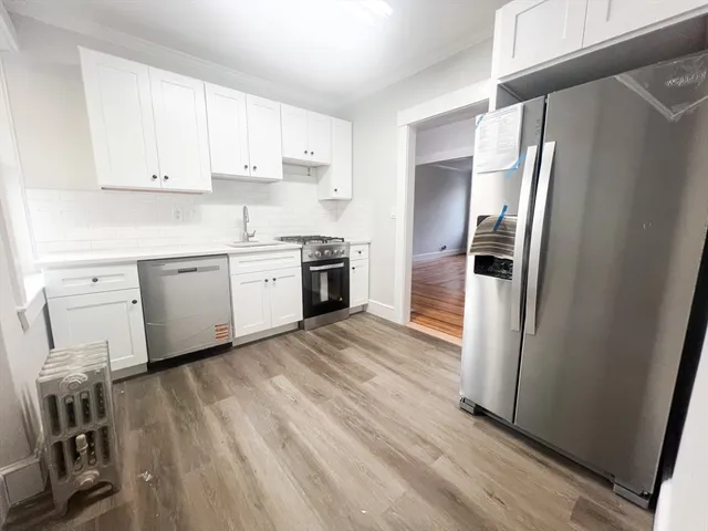a kitchen with a refrigerator a sink and dishwasher
