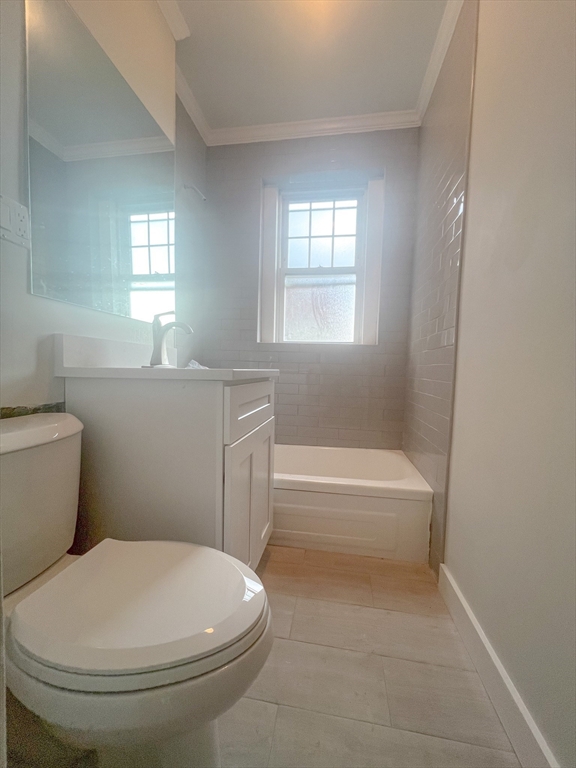 56 Selkirk Road, Unit 11 Boston, MA 02135 - Photo 3 of 6 a bathroom with a toilet a sink and bathtub