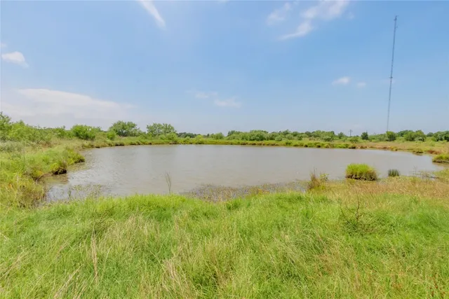 a view of a lake with houses in the back