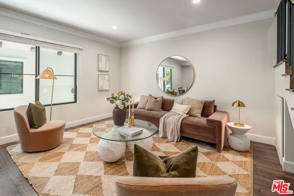 a living room with furniture and a potted plant