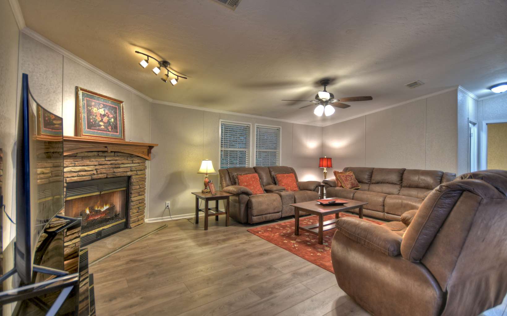 132 Rolling Oaks Road Murphy, NC 28906 - Photo 18 of 34 a living room with furniture a fireplace and a ceiling fan