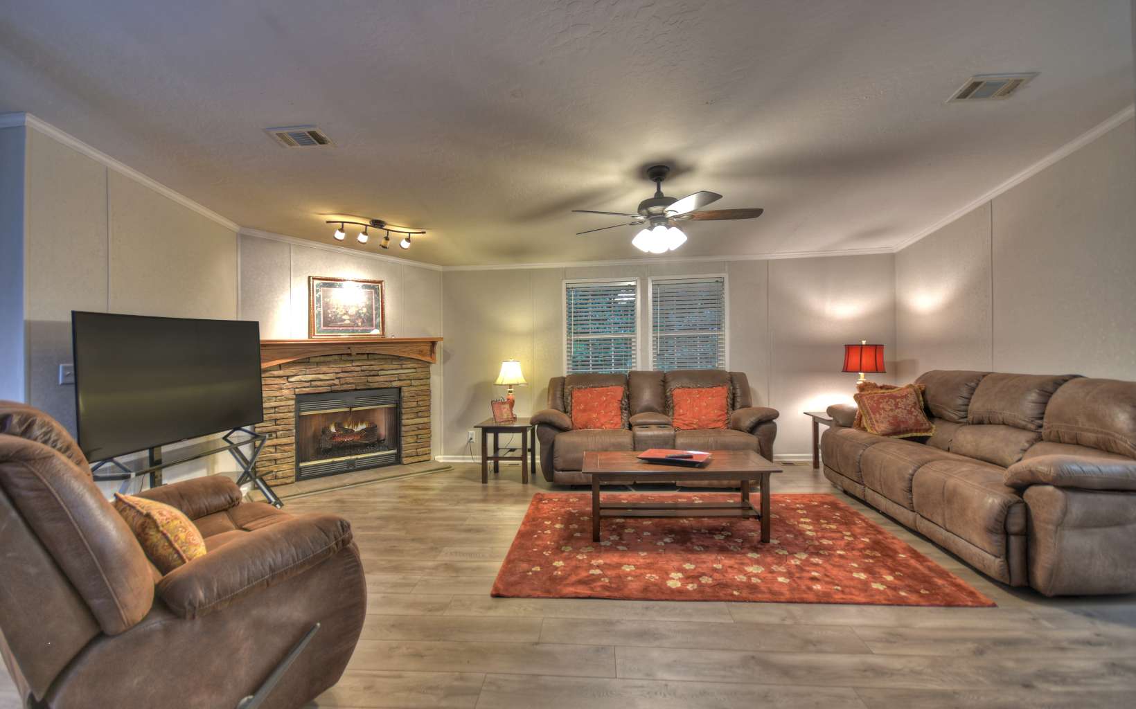 132 Rolling Oaks Road Murphy, NC 28906 - Photo 3 of 34 a living room with furniture a fireplace and a flat screen tv