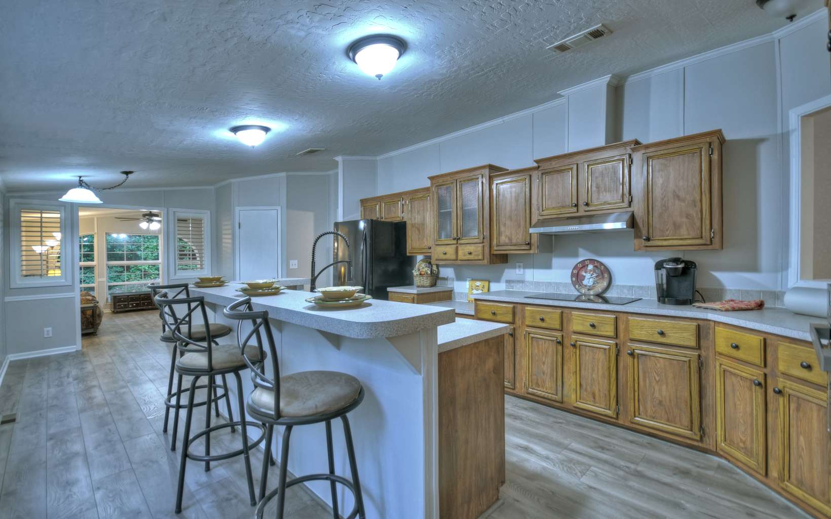 132 Rolling Oaks Road Murphy, NC 28906 - Photo 4 of 34 a kitchen with microwave a sink and chairs