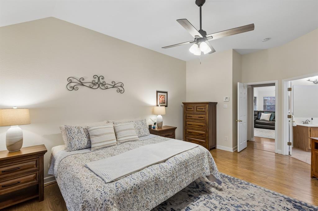 915 Rutgers Court Allen, TX 75002 - Photo 20 of 39 The primary boasts updated ceiling fan with remote, laminate flooring and an en suite bathroom.