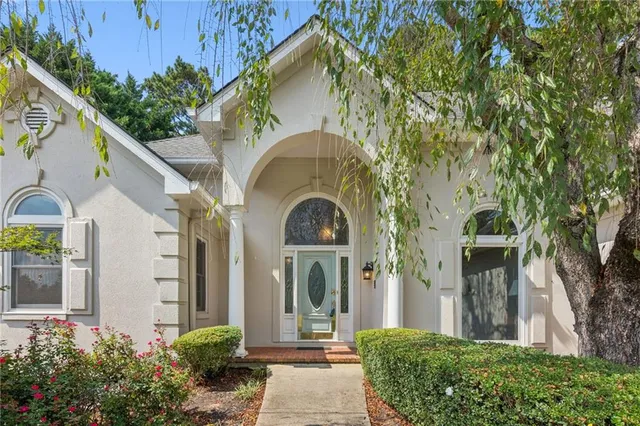 a front view of a house with a garden