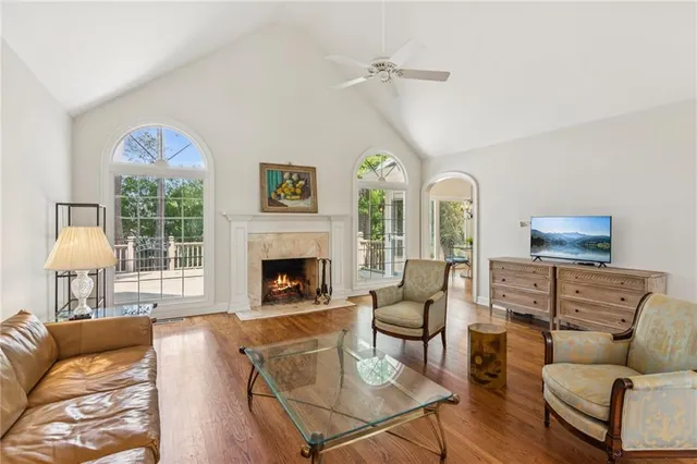 a living room with furniture a fireplace and a chandelier