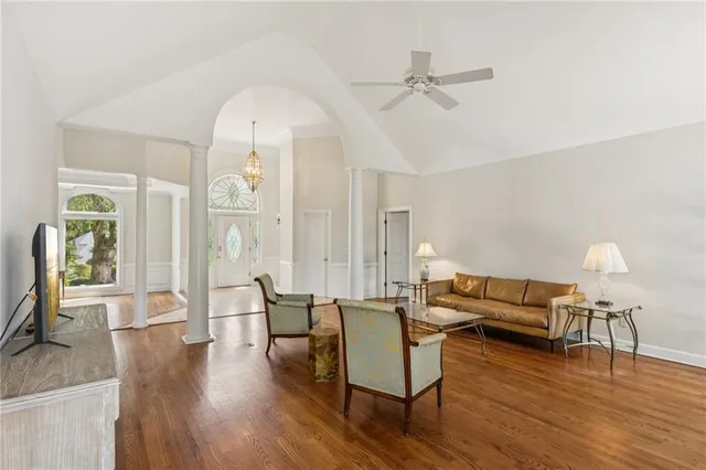 a living room with furniture and a wooden floor