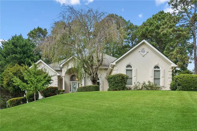 a front view of house with yard and green space