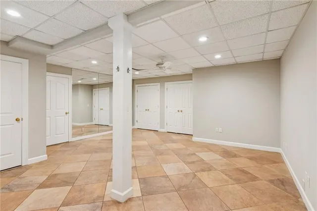 an empty room with a ceiling fan and a window