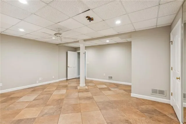 a view of backyard with a table and chairs and wooden fence
