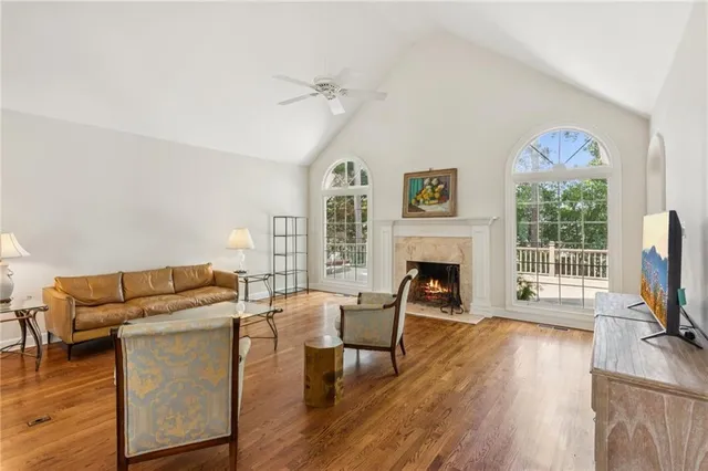 a living room with furniture a fireplace and a flat screen tv