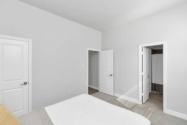 a bedroom with a bed and a bathroom