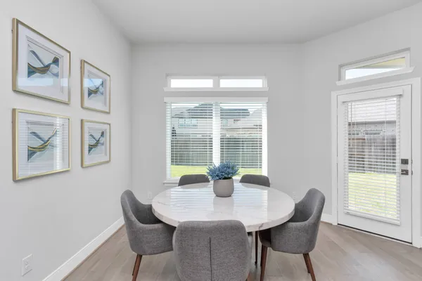 a dining room with furniture and window