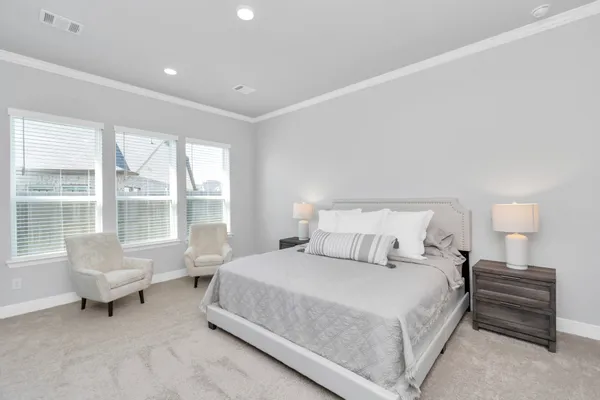 a bedroom with a bed and a large window