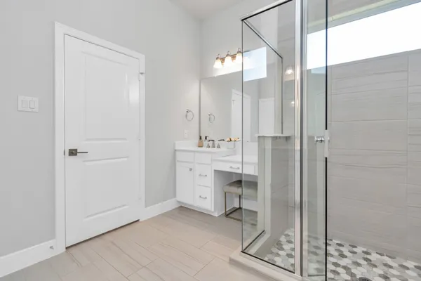 a bathroom with a shower sink and mirror