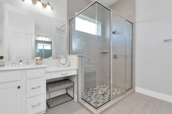a spacious bathroom with a double vanity sink mirror and shower