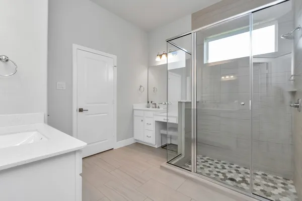 a bathroom with a shower sink and toilet