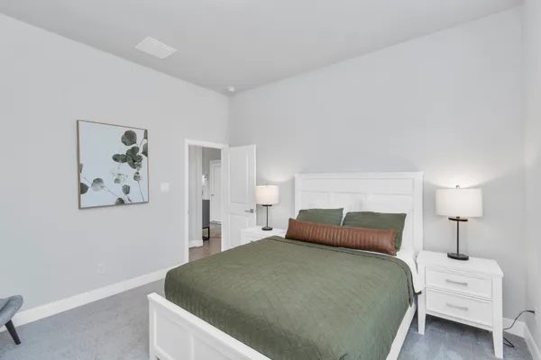 a bedroom with a bed and a painting on the wall