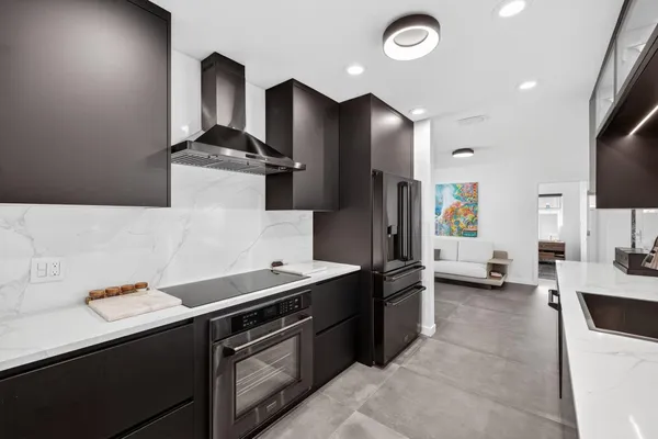 a kitchen with stainless steel appliances a sink stove and refrigerator