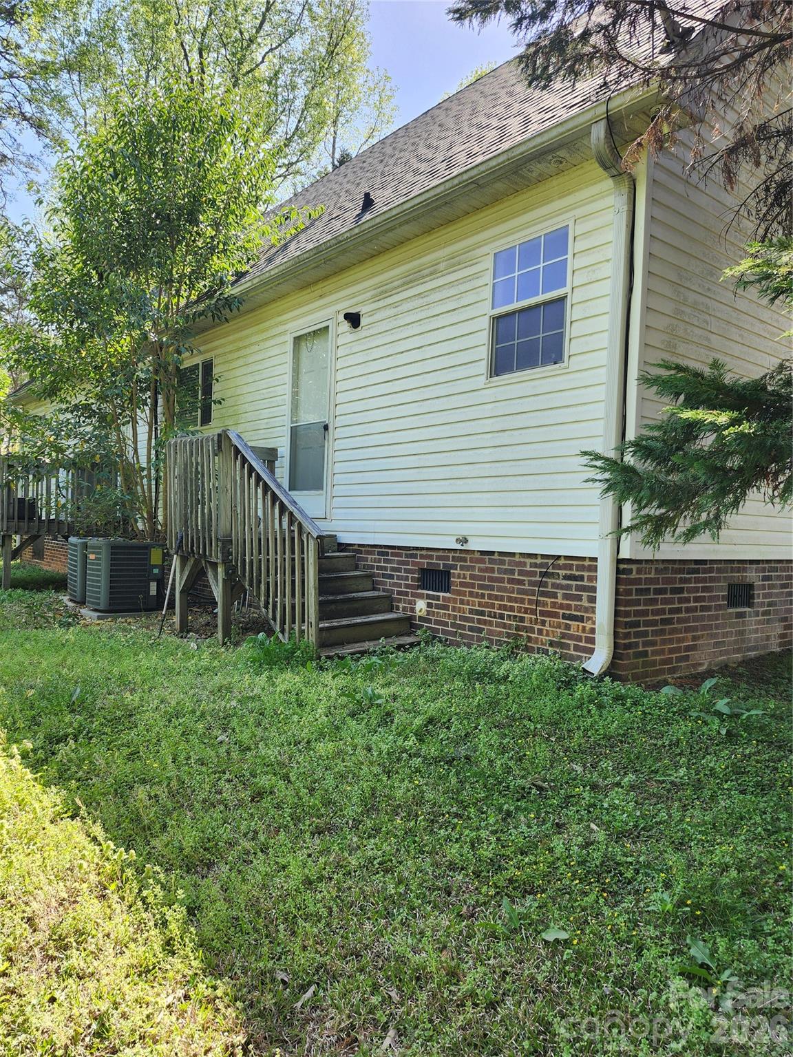 213 Vicki Way Stanley, NC 28164 - Photo 3 of 19 a view of a backyard with plants and large tree