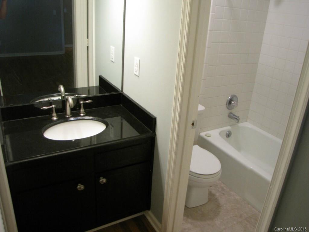 6133 Williams Road Charlotte, NC 28215 - Photo 12 of 14 a bathroom with a sink and a mirror
