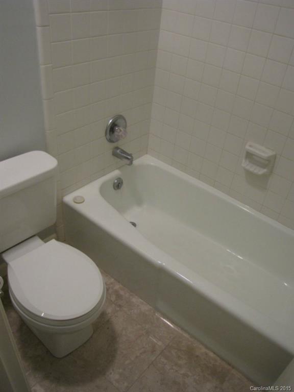 6133 Williams Road Charlotte, NC 28215 - Photo 13 of 14 a white toilet sitting next to a bath tub