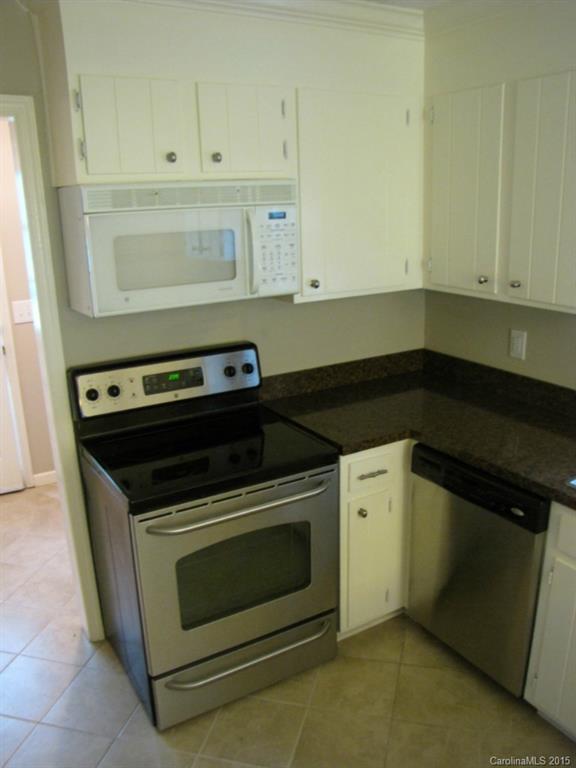 6133 Williams Road Charlotte, NC 28215 - Photo 7 of 14 a stove top oven sitting inside of a kitchen