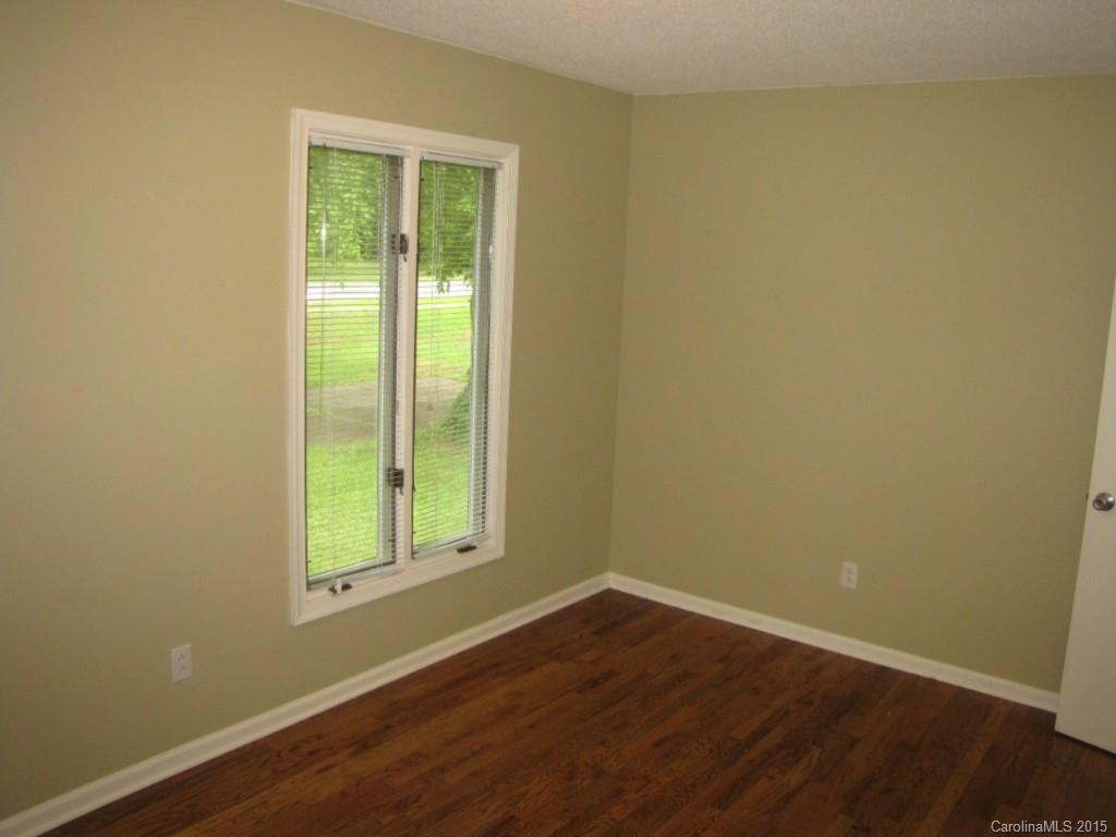 6133 Williams Road Charlotte, NC 28215 - Photo 9 of 14 an empty room with wooden floor and windows