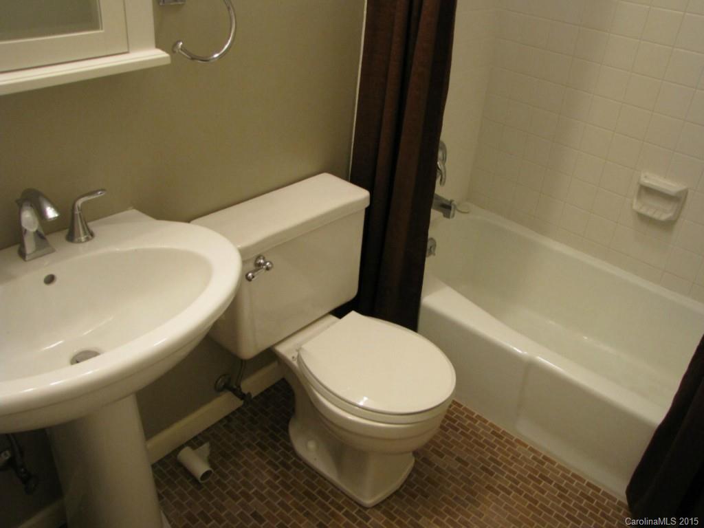 6133 Williams Road Charlotte, NC 28215 - Photo 10 of 14 a white toilet sitting next to a bathroom sink